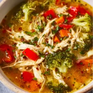 Bowl of wholesome detox soup with fresh vegetables and herbs