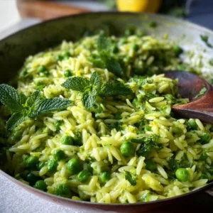 Plate of easy lemon orzo pasta with zucchini and peas