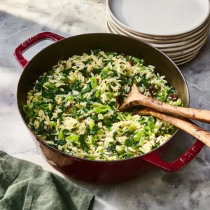 One Pan Spinach and Feta Orzo garnished with fresh herbs and lemon zest